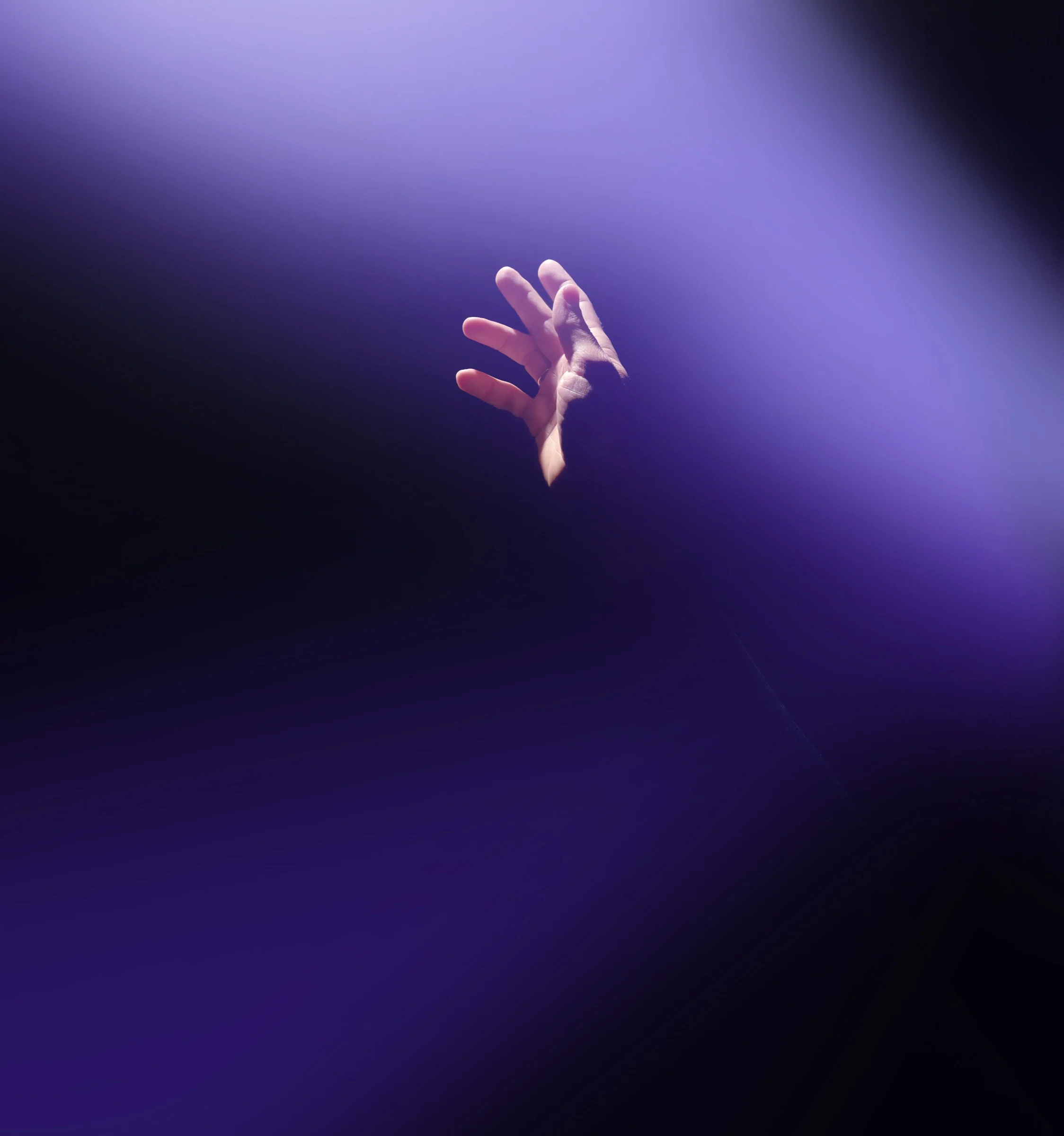 MAGUS brand photograph with a hand and purple lighting