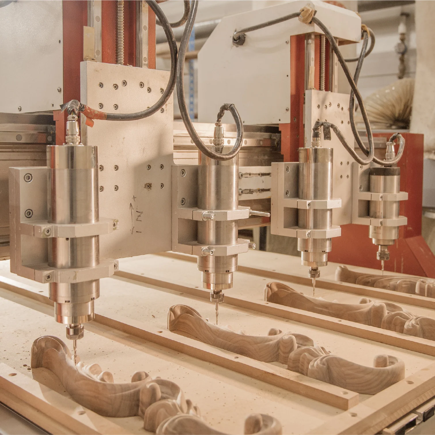 Multi-spindle CNC machine carving a series of wooden parts
